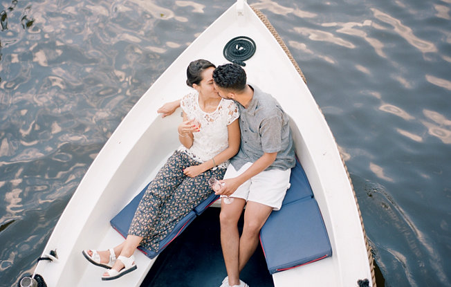 A couple kissing on a boat