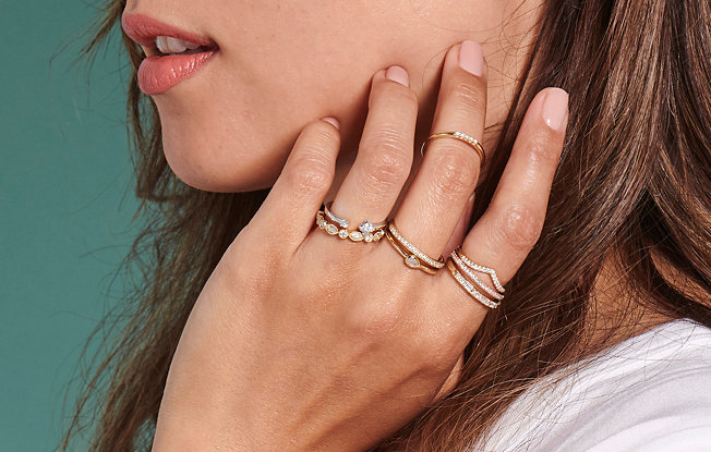 Woman wearing stacks of rings on three of her fingers