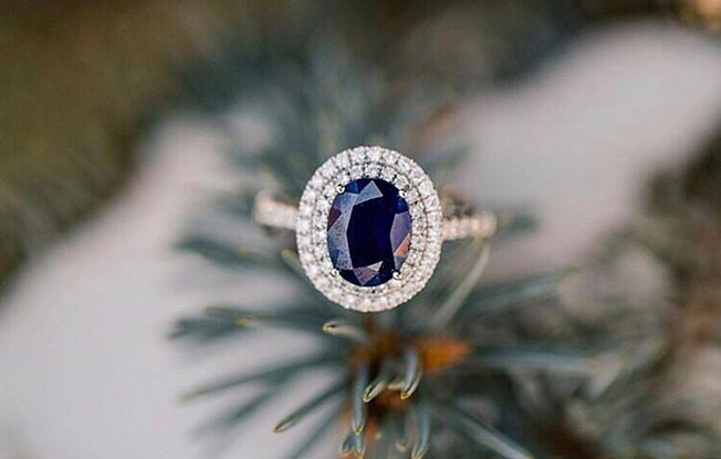 Sapphire and diamond halo engagement ring.
