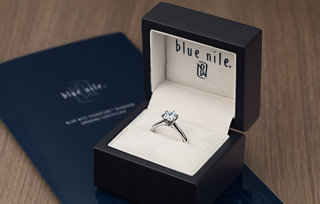 A Blue Nile diamond ring displayed in their signature box