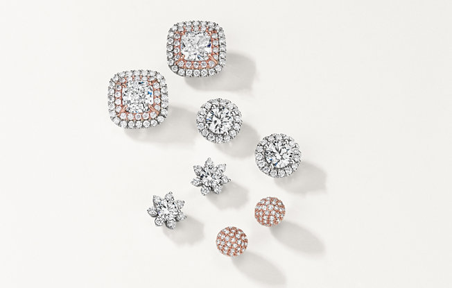 4 sets of diamond earrings in white and rose gold on a white background