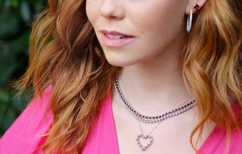 Valentine's Day jewelry selections shown in a close up as they're worn by a woman.