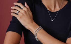 Close up of woman wearing platinum jewelry and white gold jewelry. 