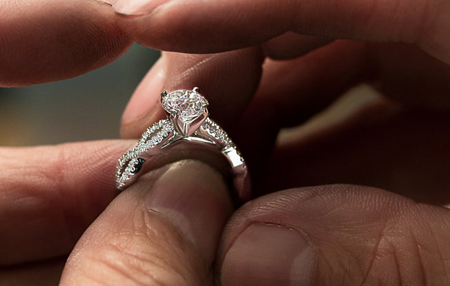 Jewelry designer creating a diamond engagement ring.