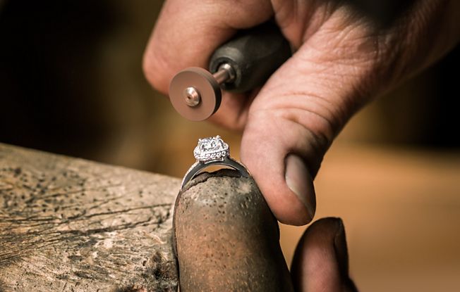 Expert crafting an engagement ring.