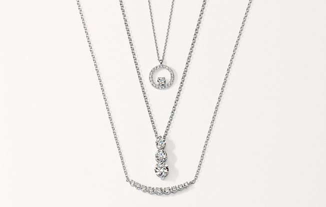 Diamond necklaces stacked together.