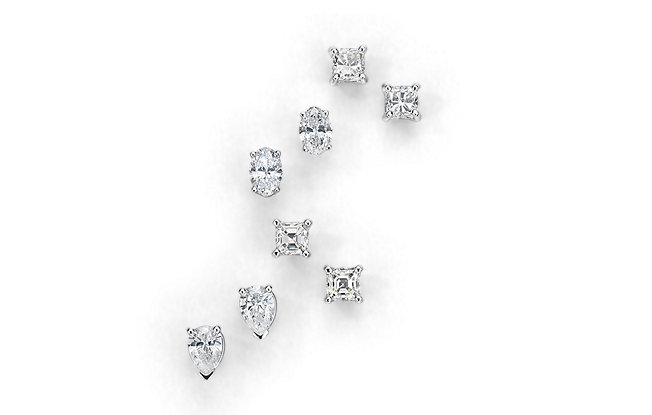 Four pairs of diamond stud earrings on a white background 