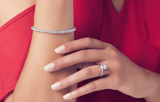 Close up of woman wearing diamond jewelry.