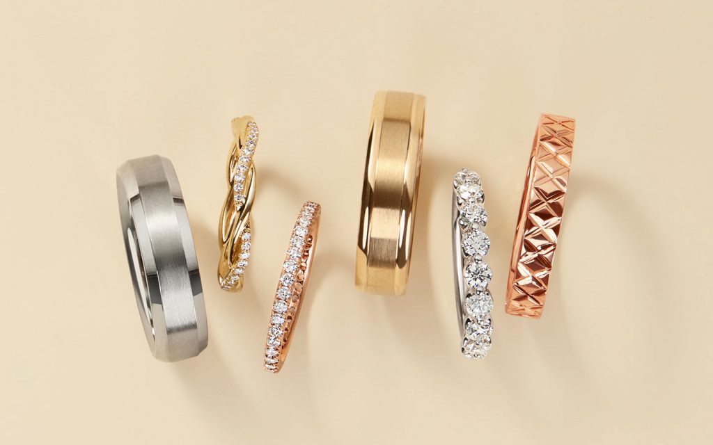 Six wedding bands including plain metal, gold and diamond styles.