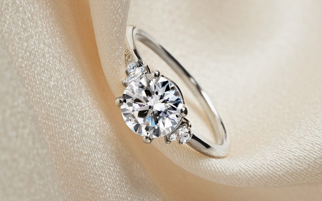 White gold diamond engagement ring with a round brilliant center diamond.