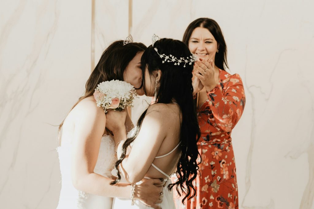Two women embracing during their commitment ceremony.
