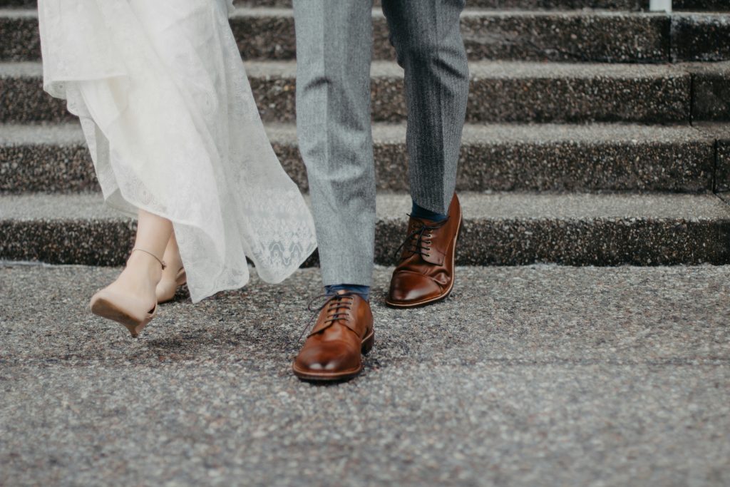 Photo of a bride and groom’s feet at the courthouse as they exit their ceremony. 