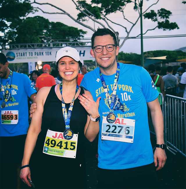 Smiling newly engaged couple at a marathon 