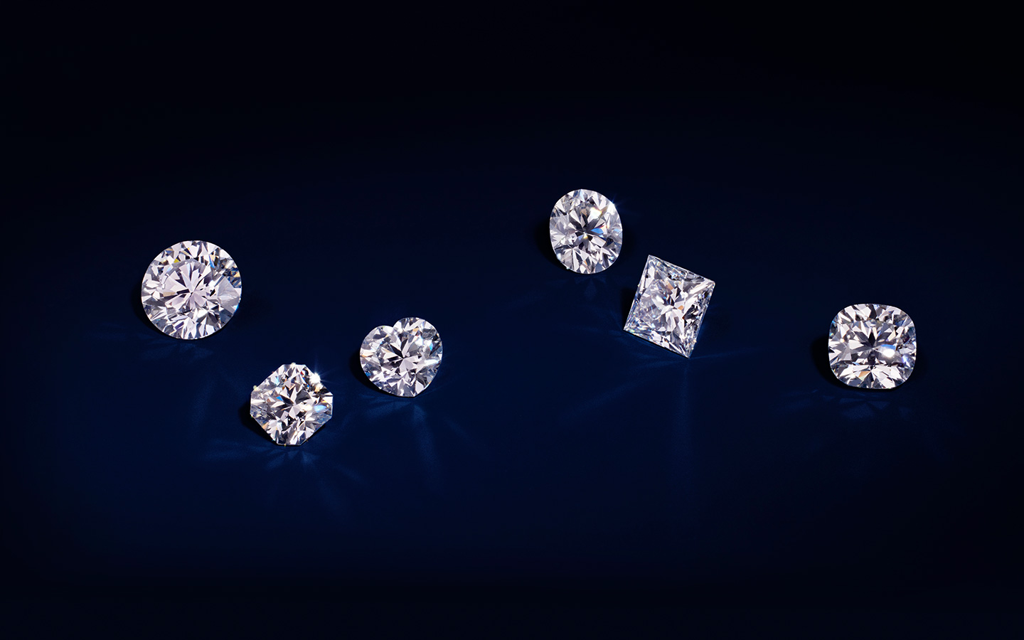 Loose diamonds in various shapes including round, princess, heart and Asscher.