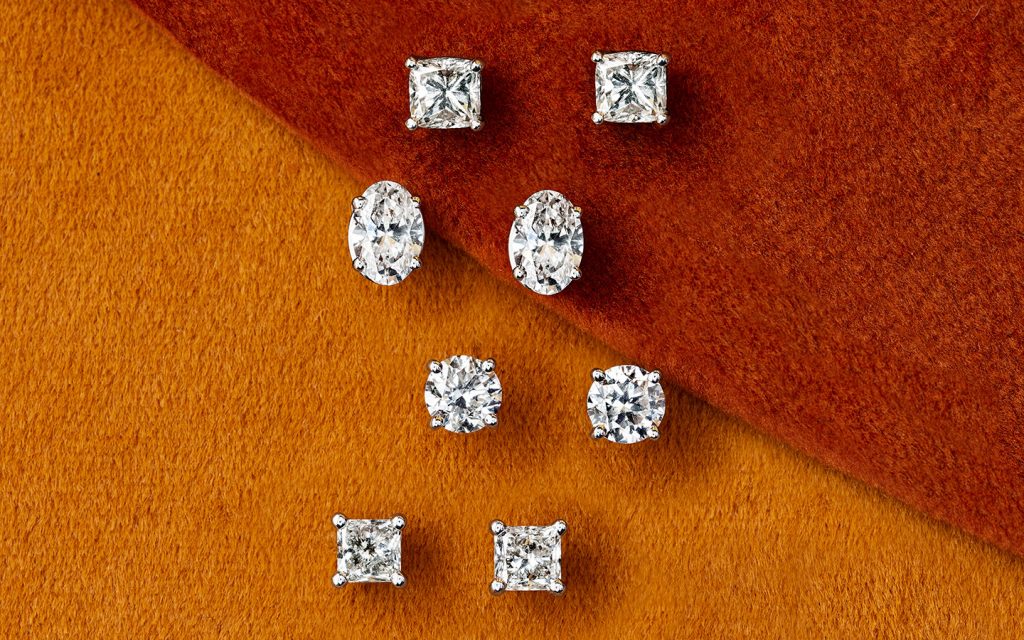 Four pairs of diamond stud earrings as viewed from above. 