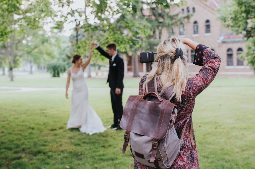 Wedding photographer taking a photo of a bride and groom during their elopement