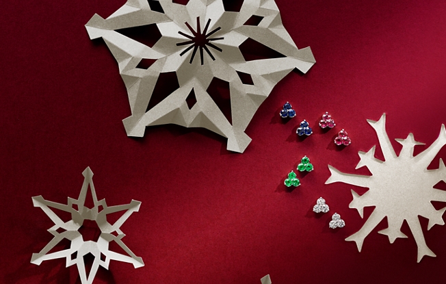 Gemstone jewelry displayed with paper snowflakes.