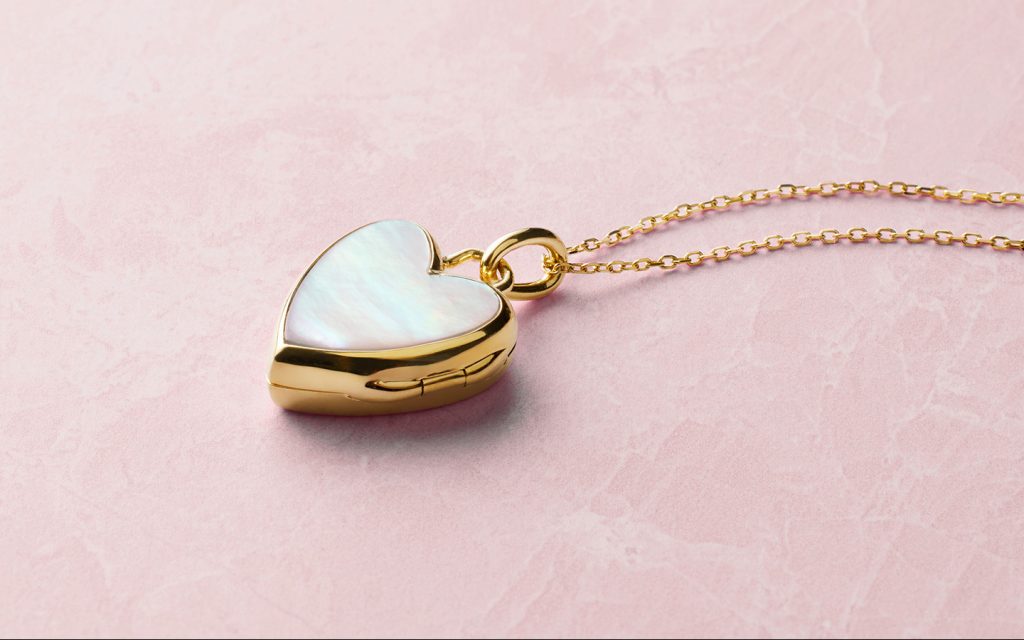 Yellow gold and mother of pearl heart locket.