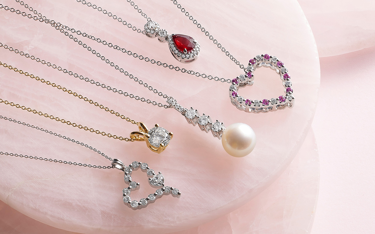 Five gemstone and diamond necklaces including two heart necklaces.
