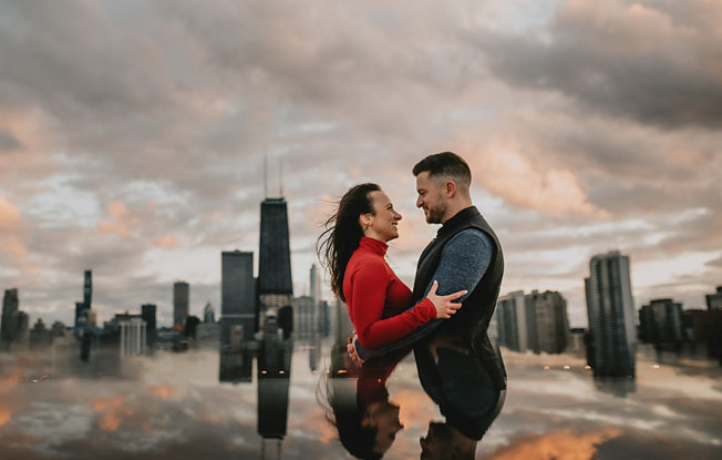 A couple embraces against a city skyline
