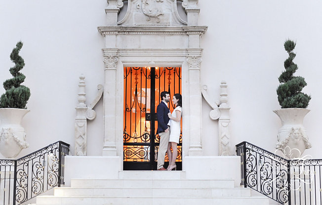 A couple stands in the doorway of an old building