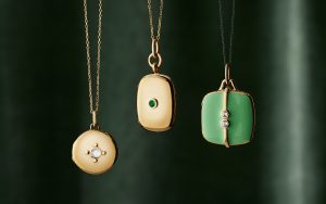 Three round, rectangle and square gold lockets with gemstones and enamel.