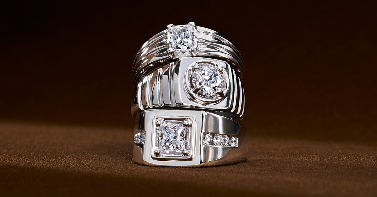Stack of three men’s engagement rings with white gold and diamonds.