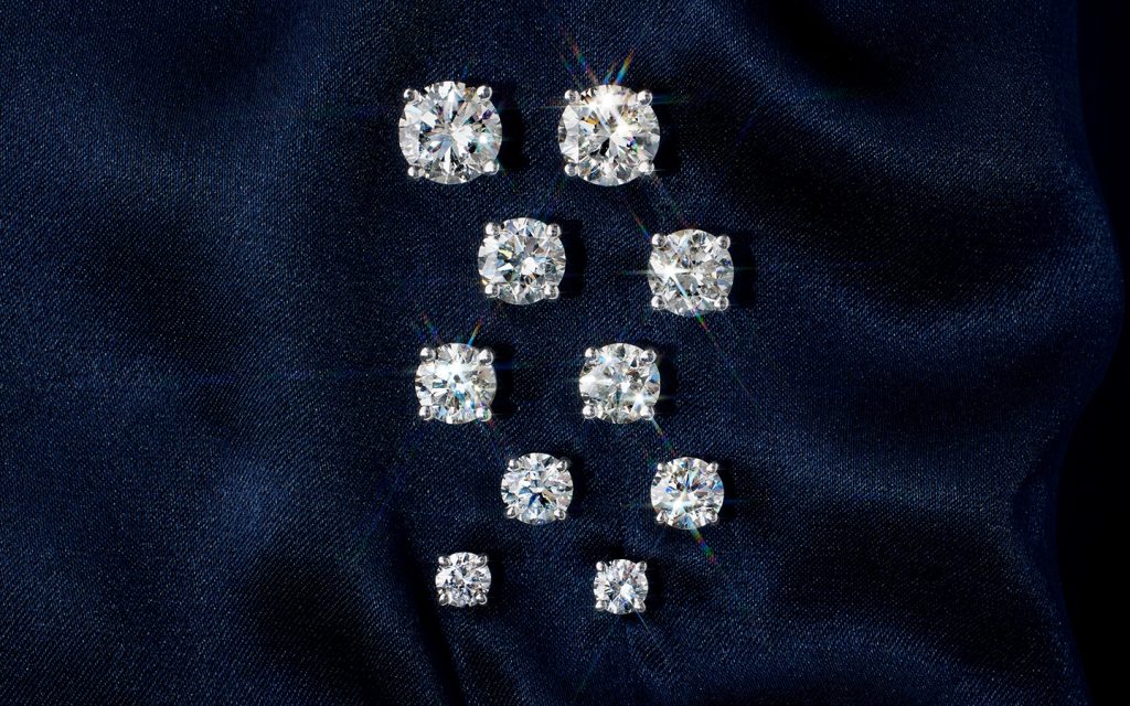 Five pairs of diamond stud earrings.