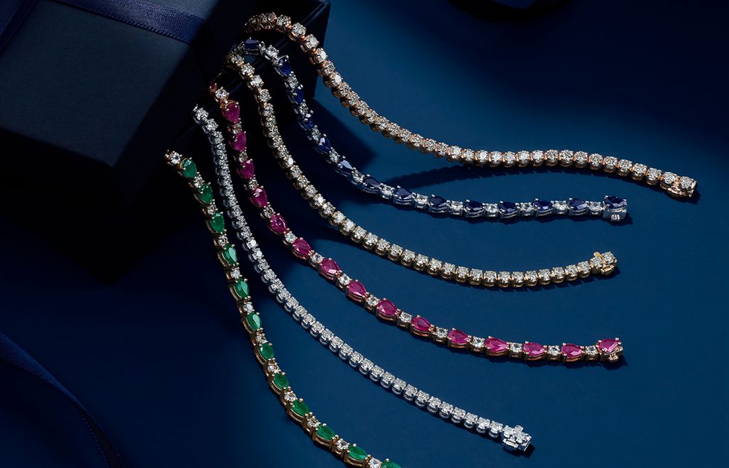 Diamond and gemstone tennis bracelets. 