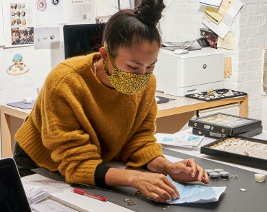 Designer Wing Yau in her studio looking at Botswana diamonds