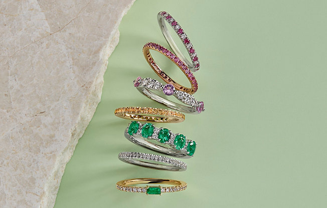 Stack of gold and gemstone rings.