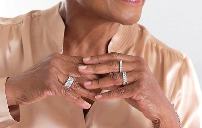 Woman wearing stacked rings.