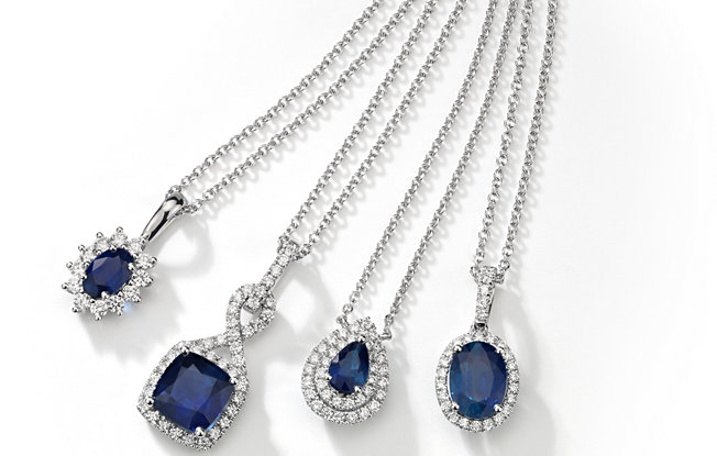 Four sapphire necklaces with diamond accents from Blue Nile on a white background