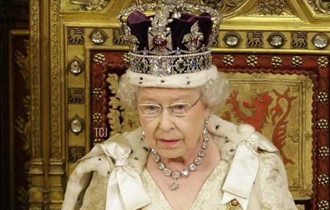 Queen Elizabeth on the throne wearing the Imperial State Crown