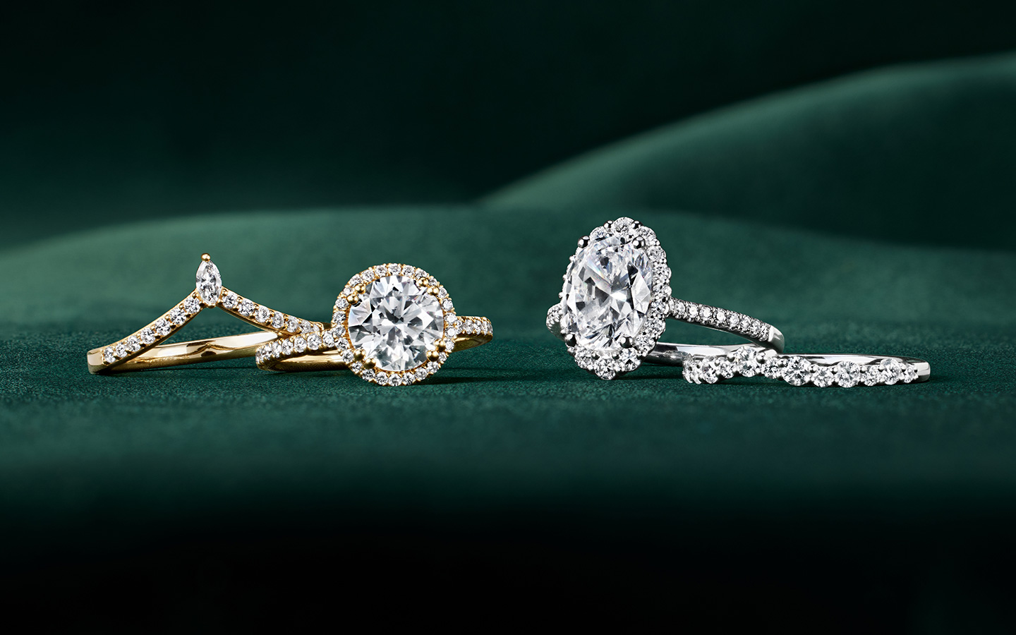 Gold and diamond engagement rings and wedding bands with oval and round diamonds.