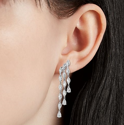 Photo of a woman’s drop earring. 