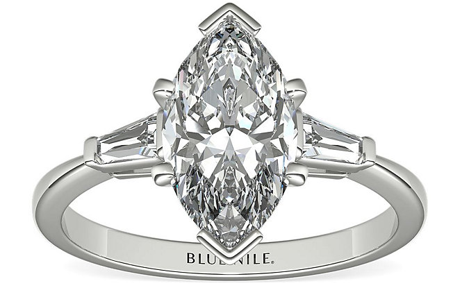 Three-stone engagement ring in white gold.