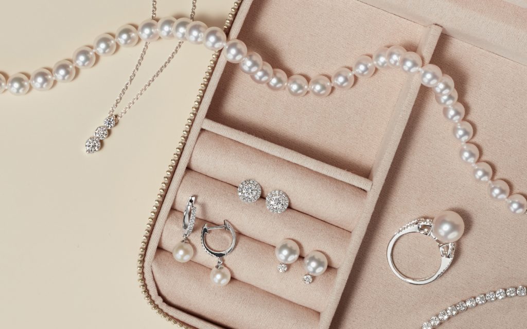 Pearl and diamond jewelry in a travel jewelry case.