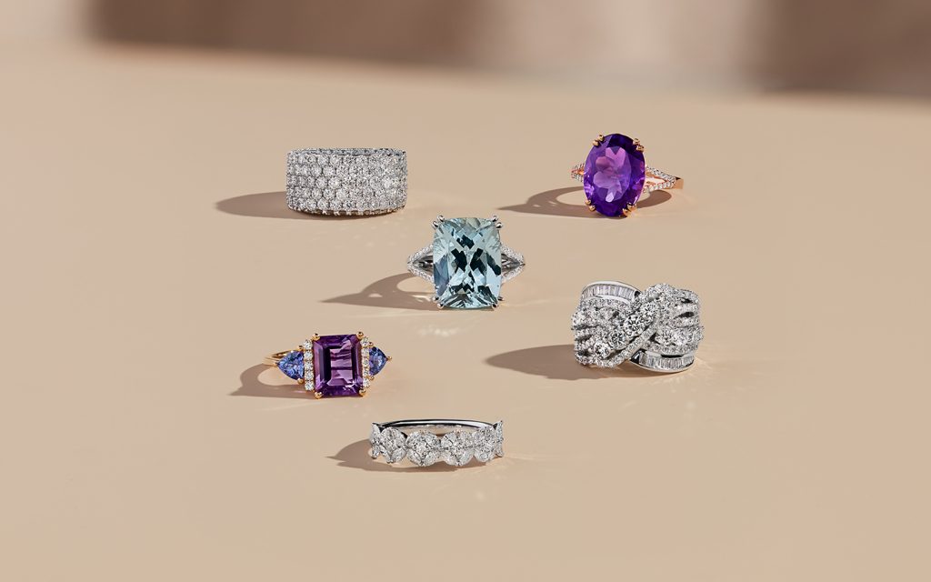 Six unique gemstone and diamond engagement rings including amethyst and blue topaz rings. 