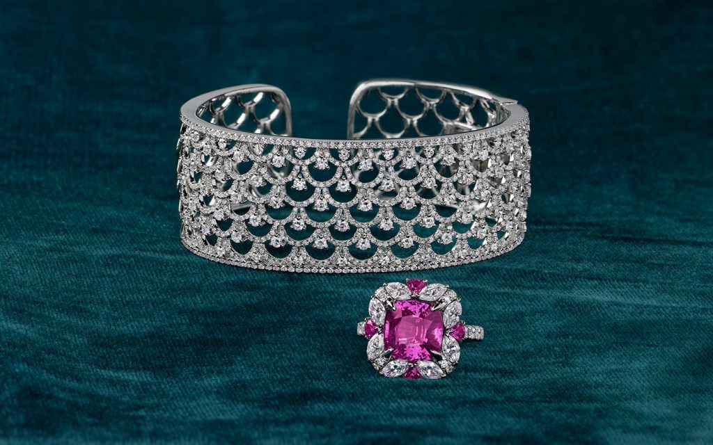 Diamond bracelet and gemstone diamond ring on a dark background. 