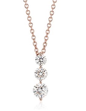 Rose gold necklace with three diamonds in graduating sizes. 