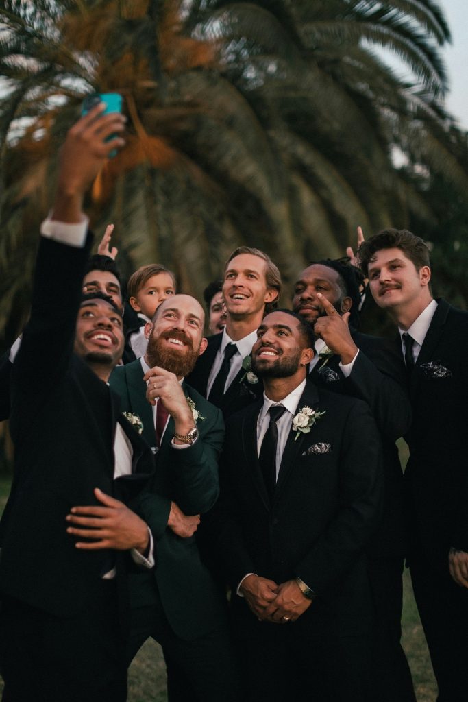 Groomsmen taking a selfie on a wedding day. 