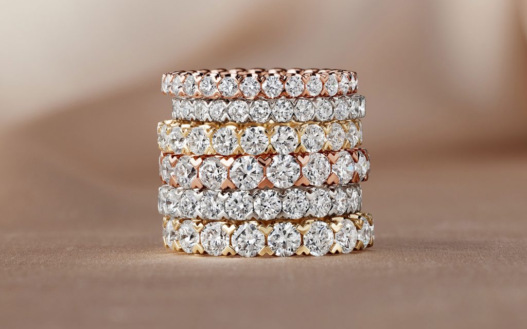 Stack of rose, yellow and white gold wedding rings with diamonds. 