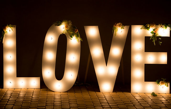 Sign that spells the word "love" in light bulbs.