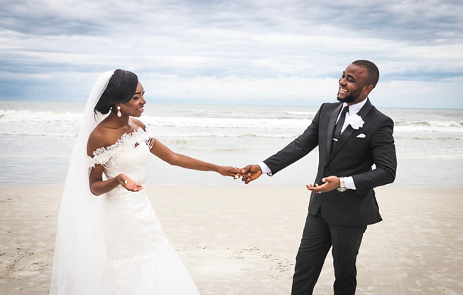 Bride and groom holding hands at their beach wedding.