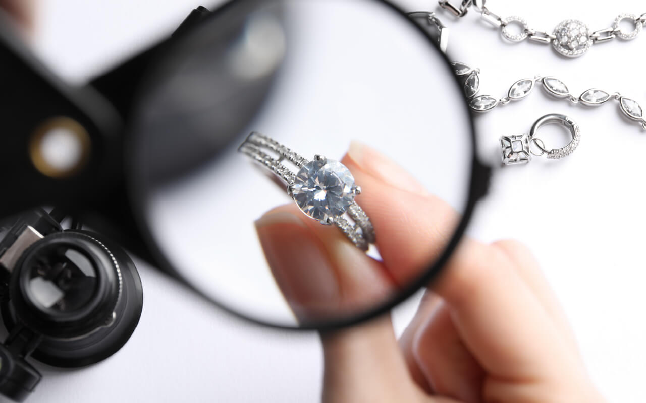 Jewelry looking through a loupe to examine a ring