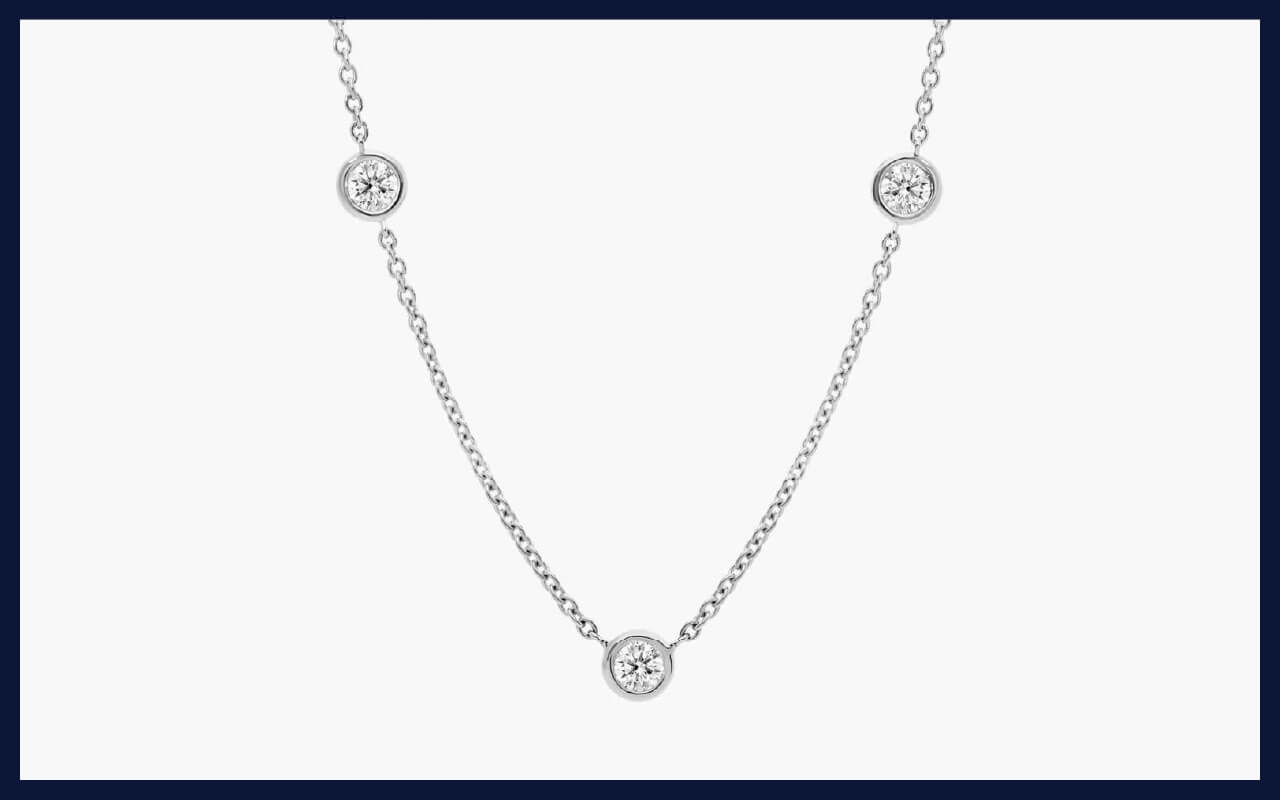 A 14K white gold lab-grown diamond station necklace with bezel settings