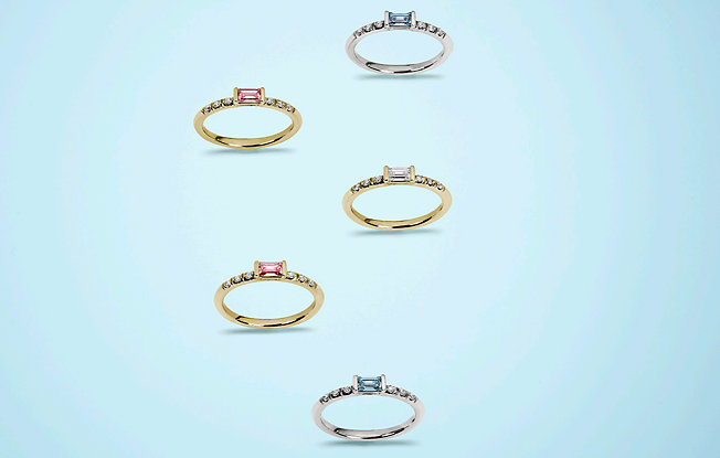 five rings adorned with blue and pink baguette lightbox lab grown diamonds on a blue background