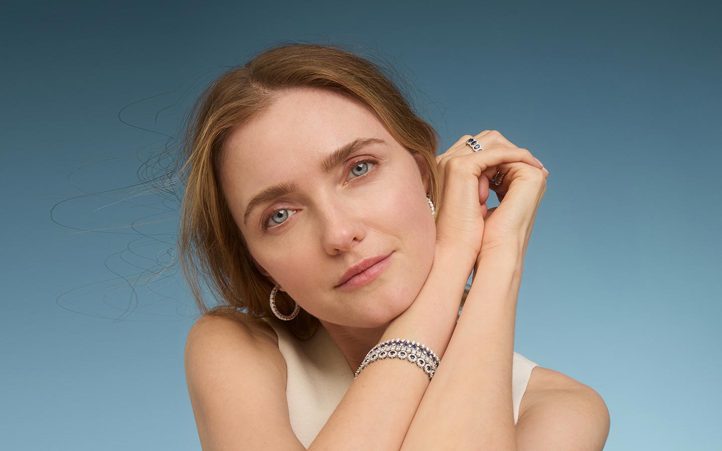 Woman wearing gold sapphire jewelry