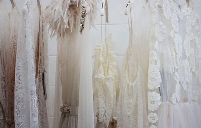6 wedding dresses hanging on a rack